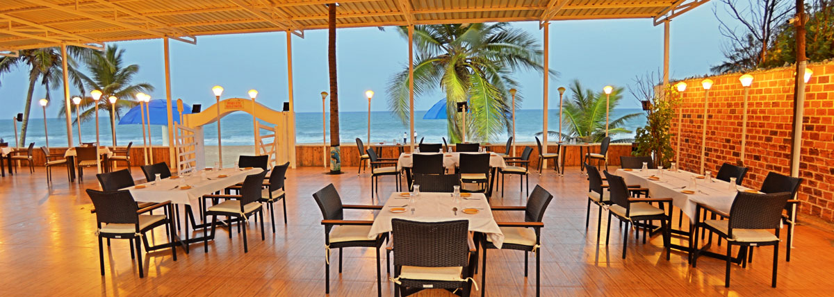 Seating arrangements of beach restaurant with a view of the sea in Bluebay beach resort, ECR, Chennai
