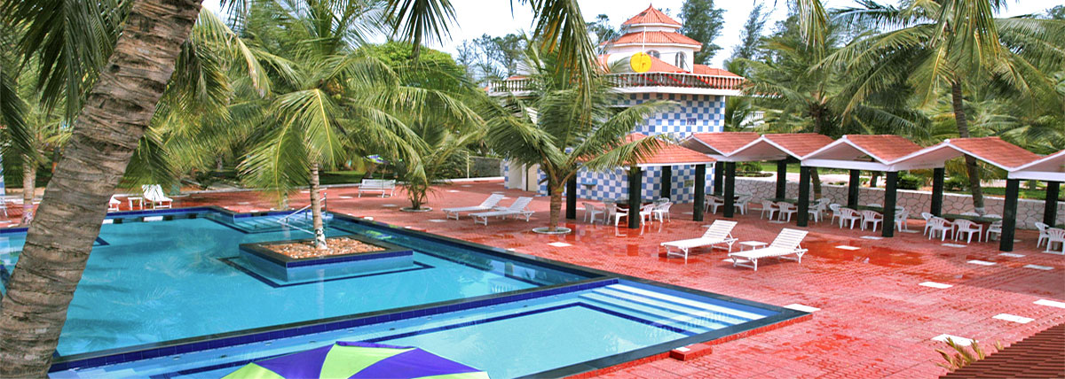 Swimmingpool with loungers, canopies in Bluebay beach resort, ECR, Chennai