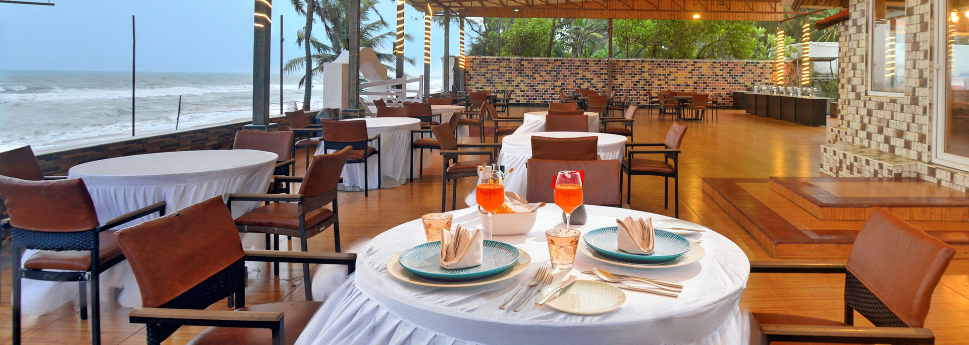 Seating arrangements of beach restaurant with a view of the sea in Bluebay beach resort, ECR, Chennai