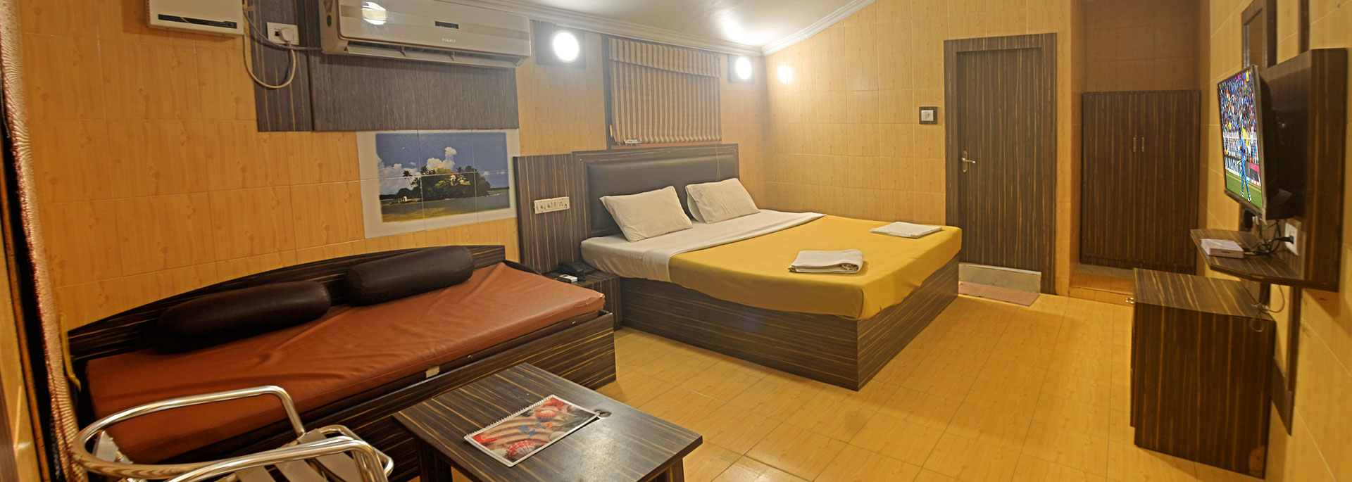 Room with kingsize bed, sofa-cum-bed, television, studying table, fan & Air conditioner, intercom in Bluebay beach resort