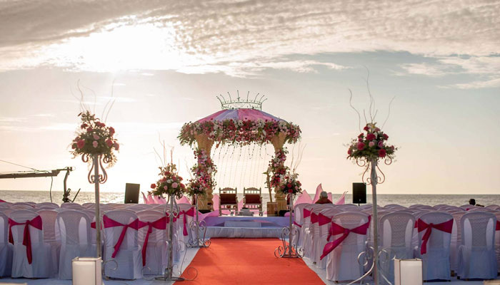 Stage arrangements with seatings in the beach for a wedding, in Bluebay Beach Resort, ECR, Chennai