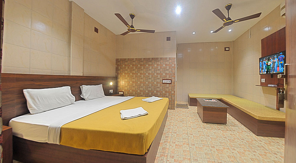 Oceanside cottage with bed, dressing table with mirror, intercom, television, sofa with table, night lamp, Airconditioner in Bluebay beach resort, ecr, chennai