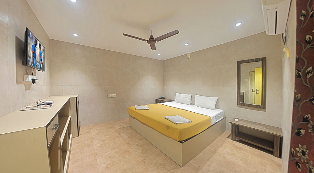 Standard room with king size bed, television with set top box, sofa-cum-bed, chairs with table, Airconditioner in Bluebay beach resort, ECR, Chennai