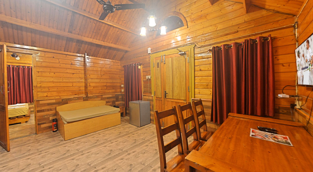 Wooden cottage with bedroom, dining table, soa, bathrooms, airconditioner, fire extinguisher in Bluebay beach resort
